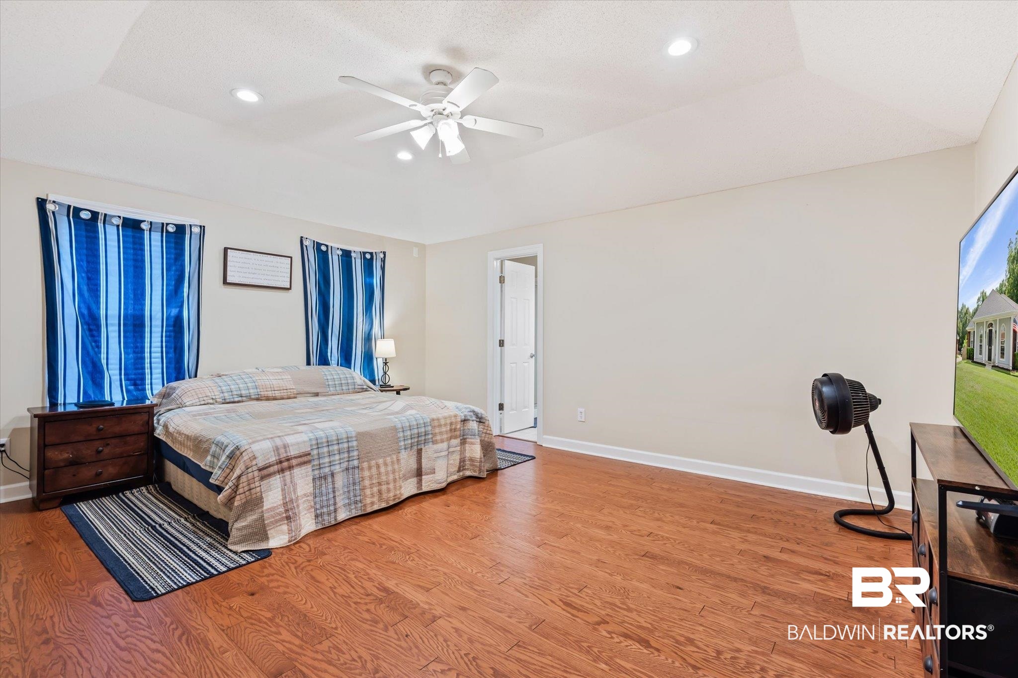 2320 Sequoya Trail Mobile, AL 36695 - Photo 9 of 20 Bedroom with lofted ceiling, a tray ceiling, hardwood / wood-style floors, and ceiling fan