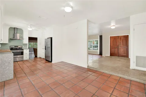 a kitchen with stainless steel appliances granite countertop a refrigerator and a stove