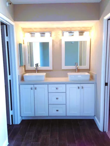 a bathroom with a granite countertop sink and a mirror