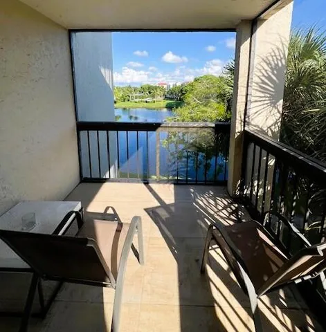 a view of a balcony with furniture