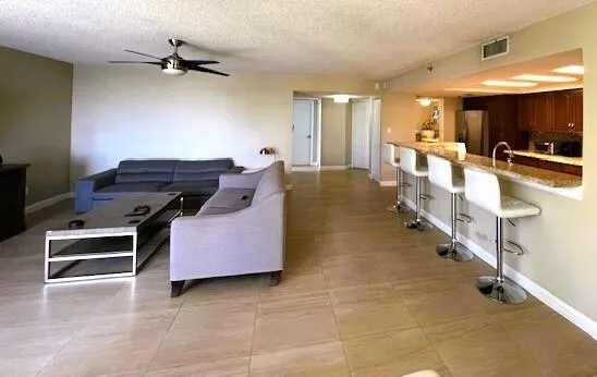 a kitchen with stainless steel appliances kitchen island granite countertop a stove and a sink