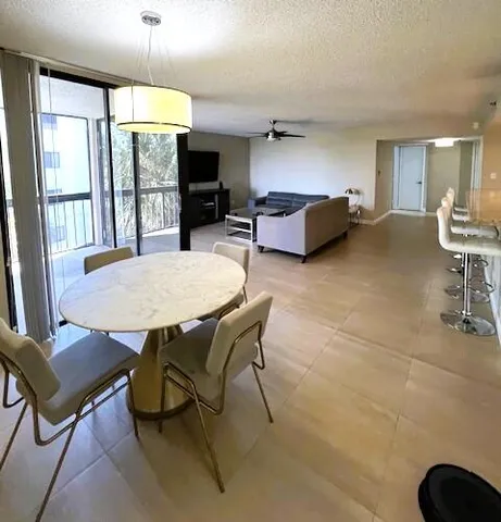 a living room with furniture a table and chairs