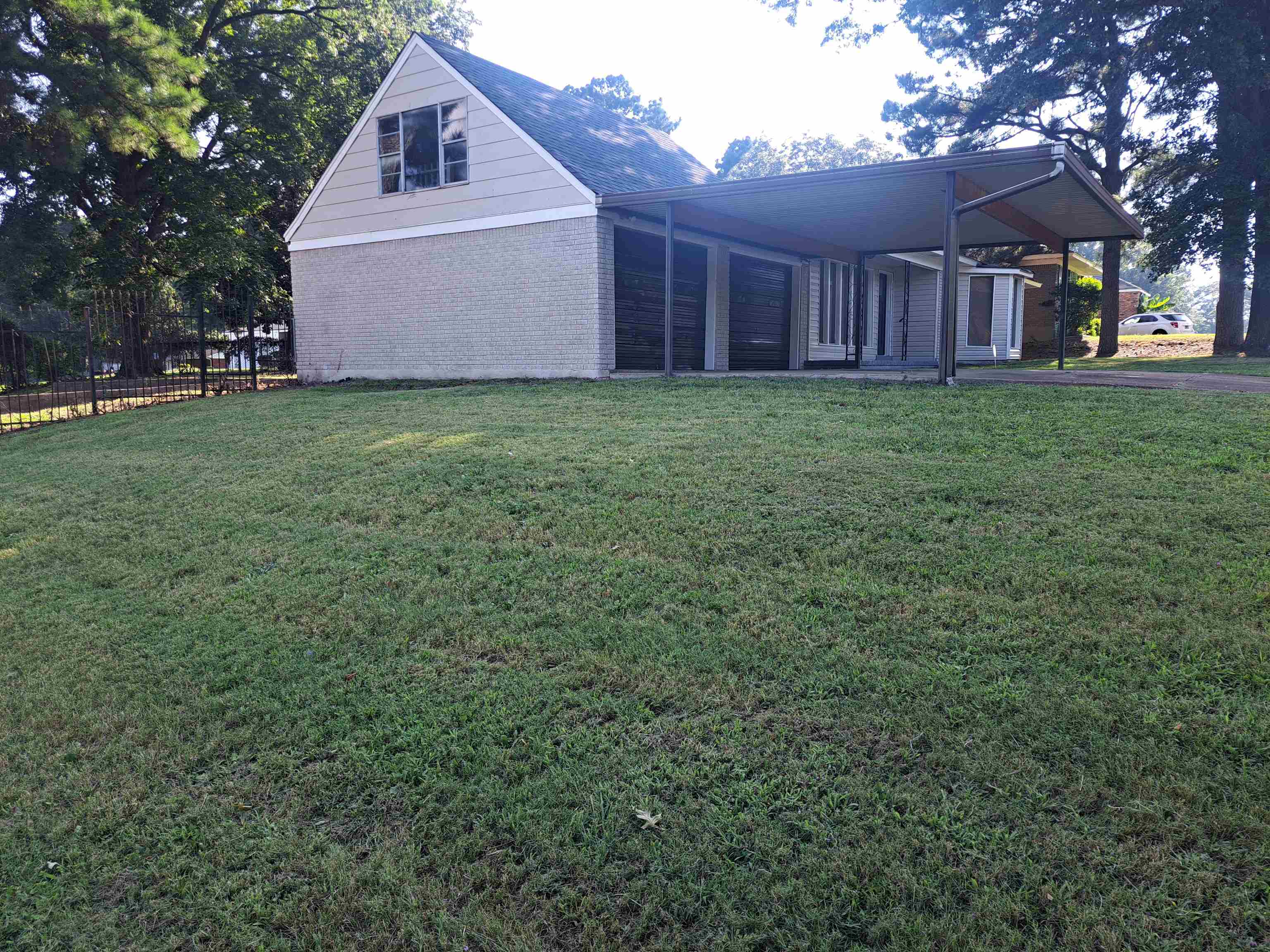 545 Dreger Road Memphis, TN 38109 - Photo 3 of 26 a view of a small yard in front of a house with a large tree