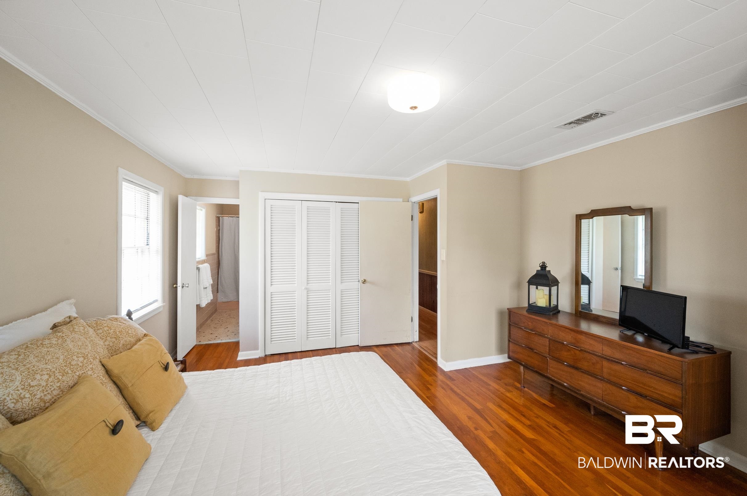 15600 Fackler Road Loxley, AL 36551 - Photo 15 of 51 Bedroom featuring hardwood / wood-style floors, crown molding, and a closet