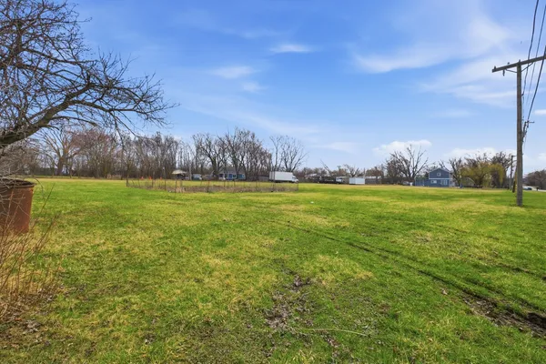 a view of yard with swimming pool and green space