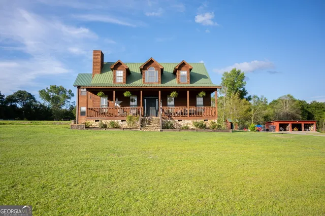 a kitchen with stainless steel appliances granite countertop wooden cabinets a sink dishwasher a stove and a refrigerator with wooden floor