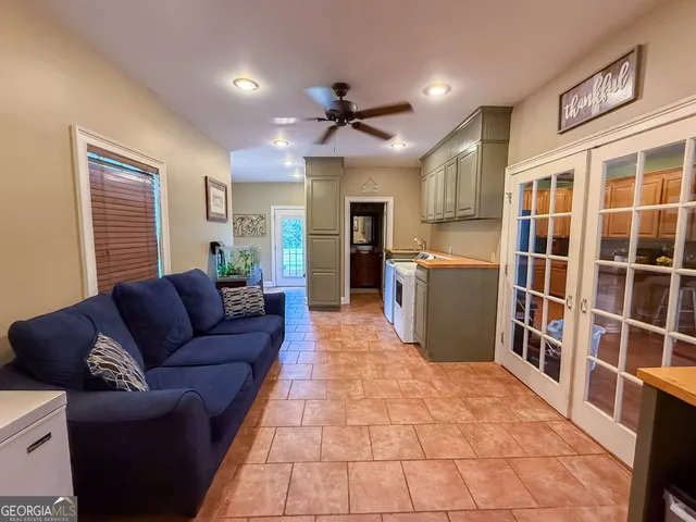 a bedroom with a bed and a ceiling fan