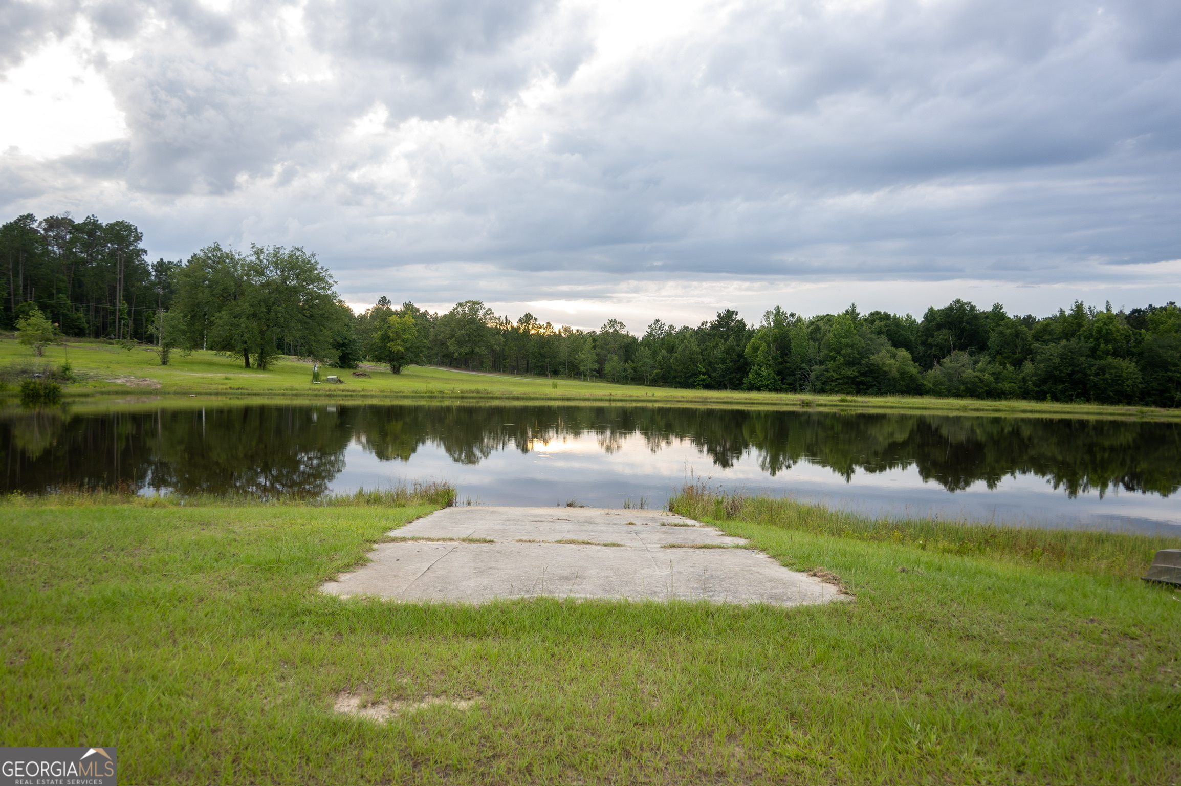 1940 Horne Road Eastman, GA 31023 - Photo 74 of 94 a view of a lake with a big yard and large trees