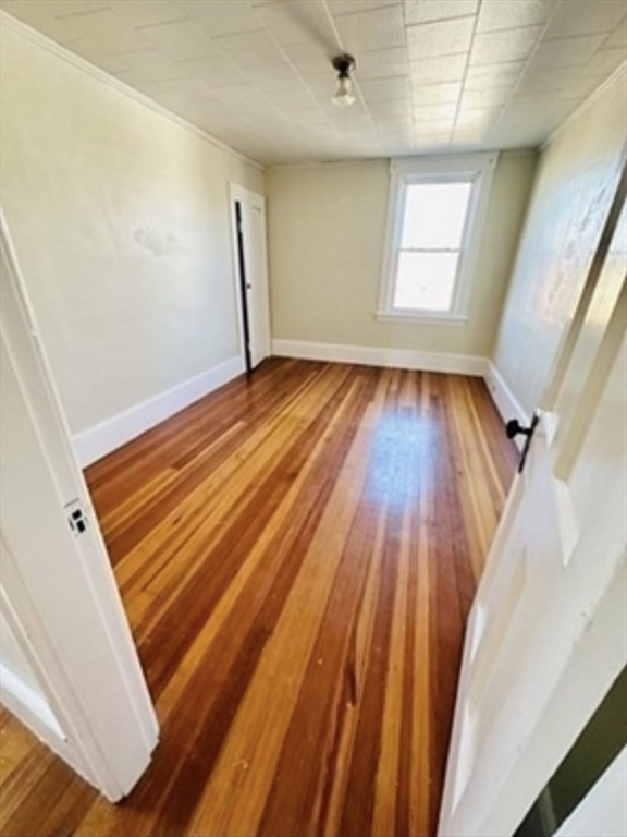 12 Princeton Avenue, Unit 2 Easthampton, MA 01027 - Photo 19 of 20 an empty room with wooden floor and windows