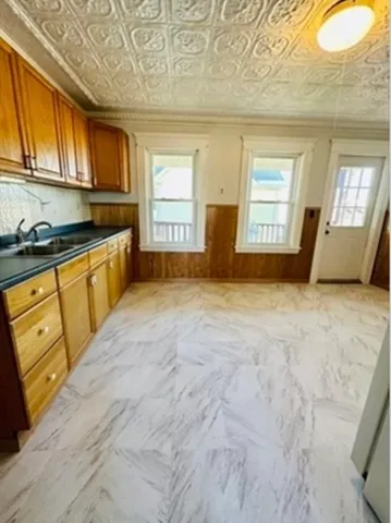 a view of a kitchen with granite countertop cabinets stainless steel appliances a window and a sink
