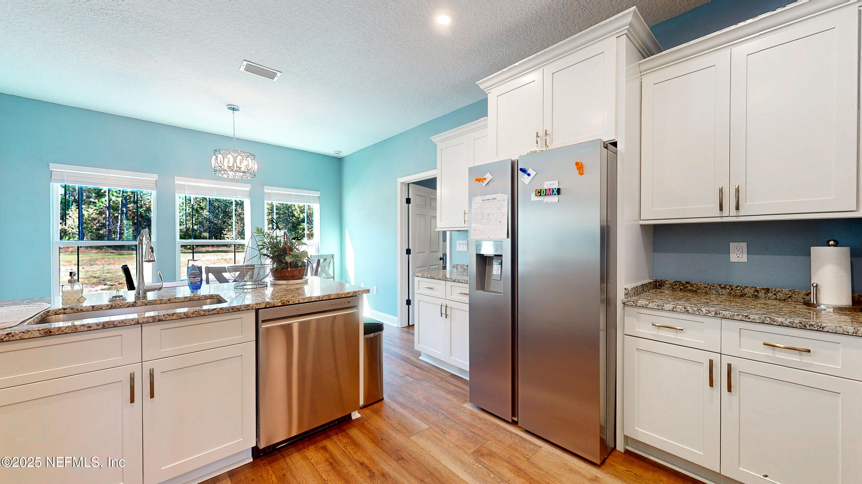 2414 Range Line Road Middleburg, FL 32068 - Photo 18 of 39 a kitchen with granite countertop a white cabinets and refrigerator