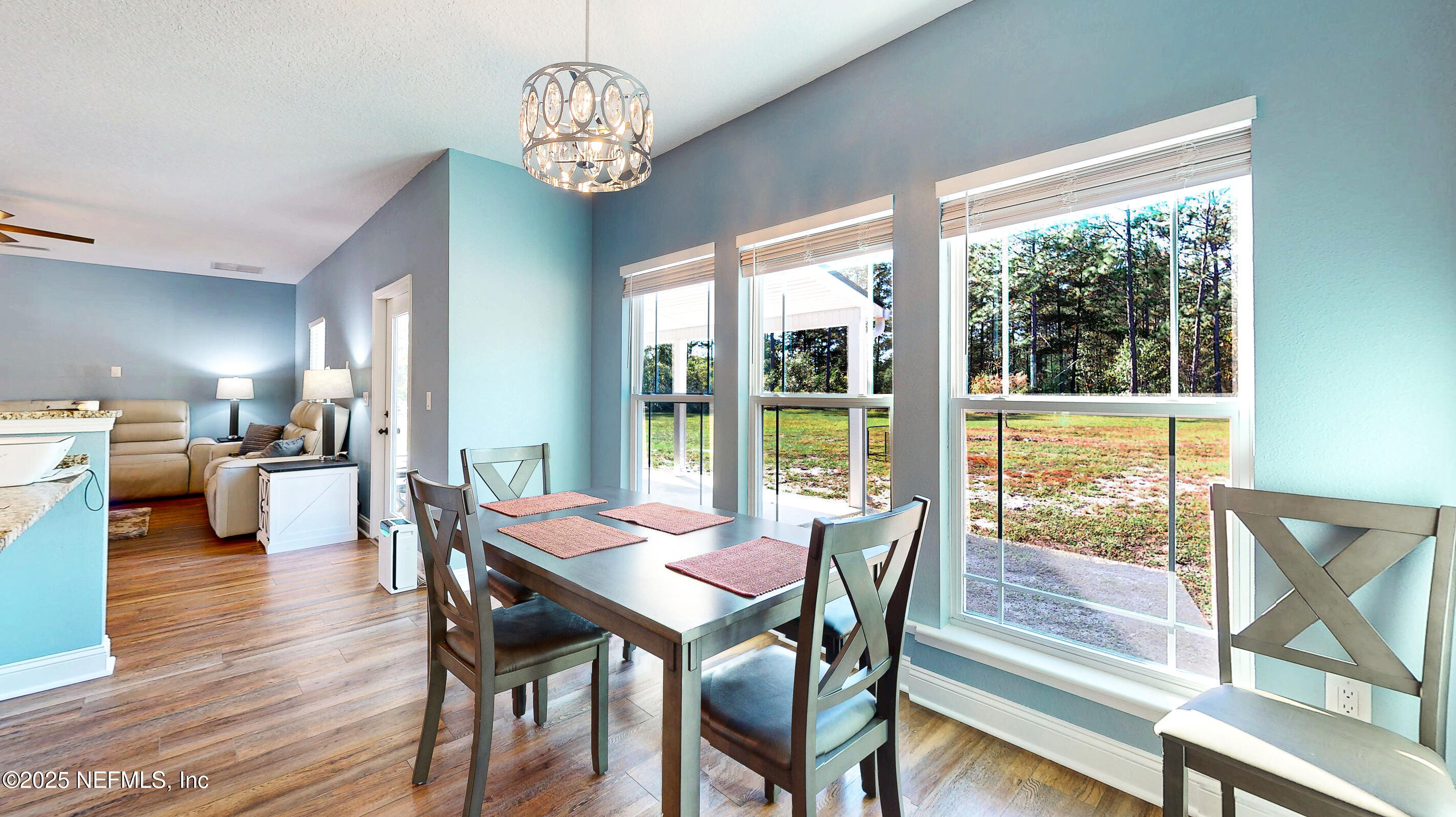 2414 Range Line Road Middleburg, FL 32068 - Photo 19 of 39 a view of a dining room with furniture wooden floor and a chandelier