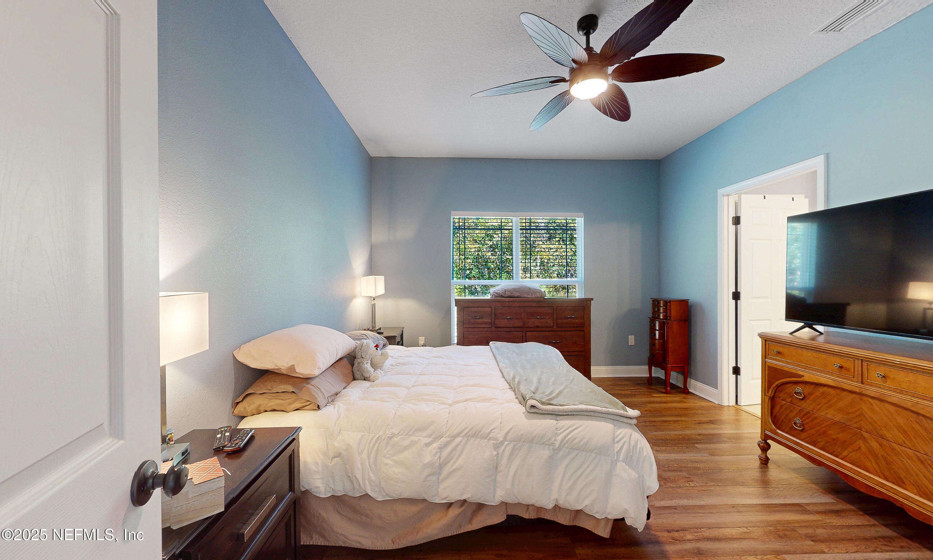 2414 Range Line Road Middleburg, FL 32068 - Photo 20 of 39 a bedroom with a bed and a flat screen tv