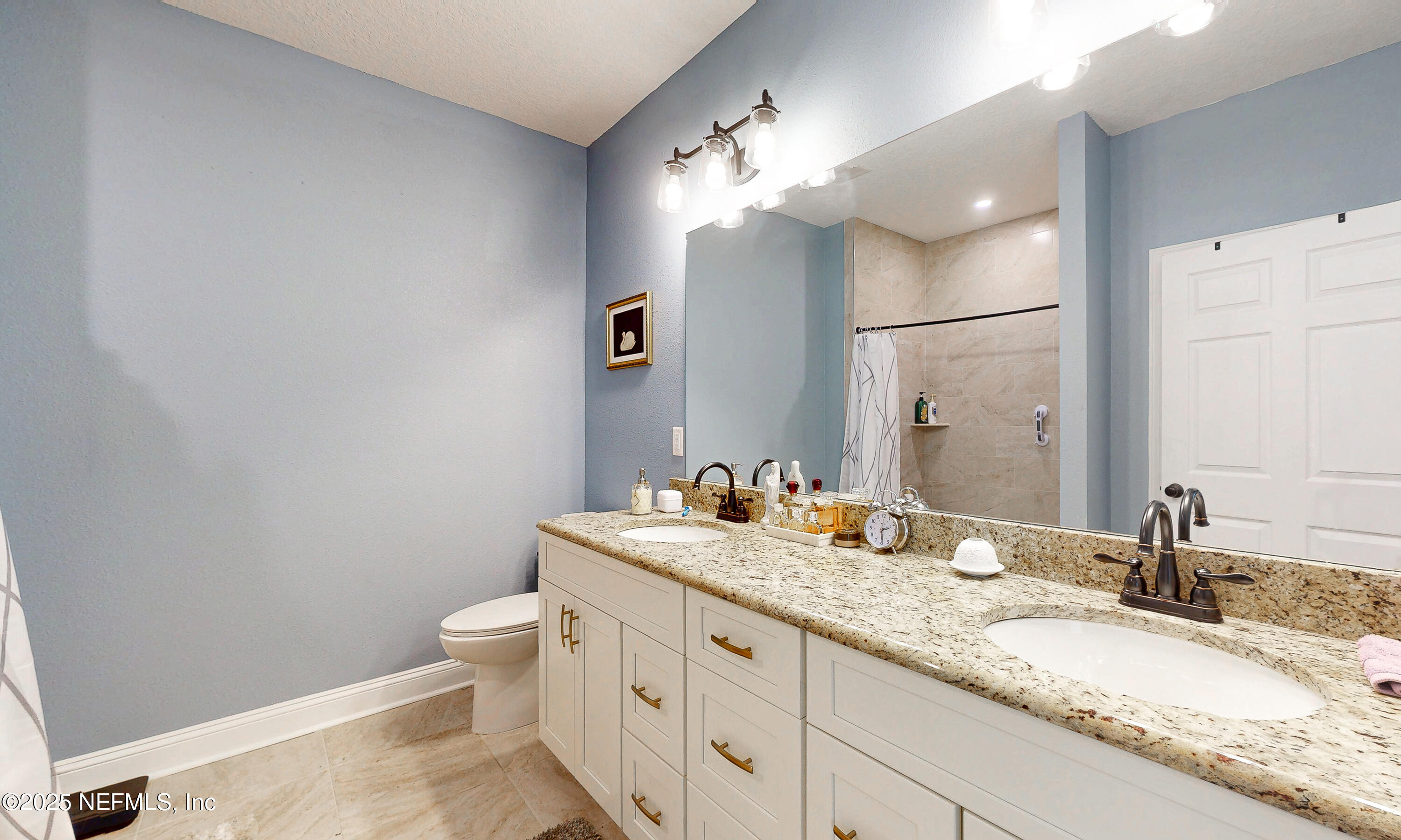 2414 Range Line Road Middleburg, FL 32068 - Photo 23 of 39 a bathroom with a granite countertop double vanity sink mirror and toilet
