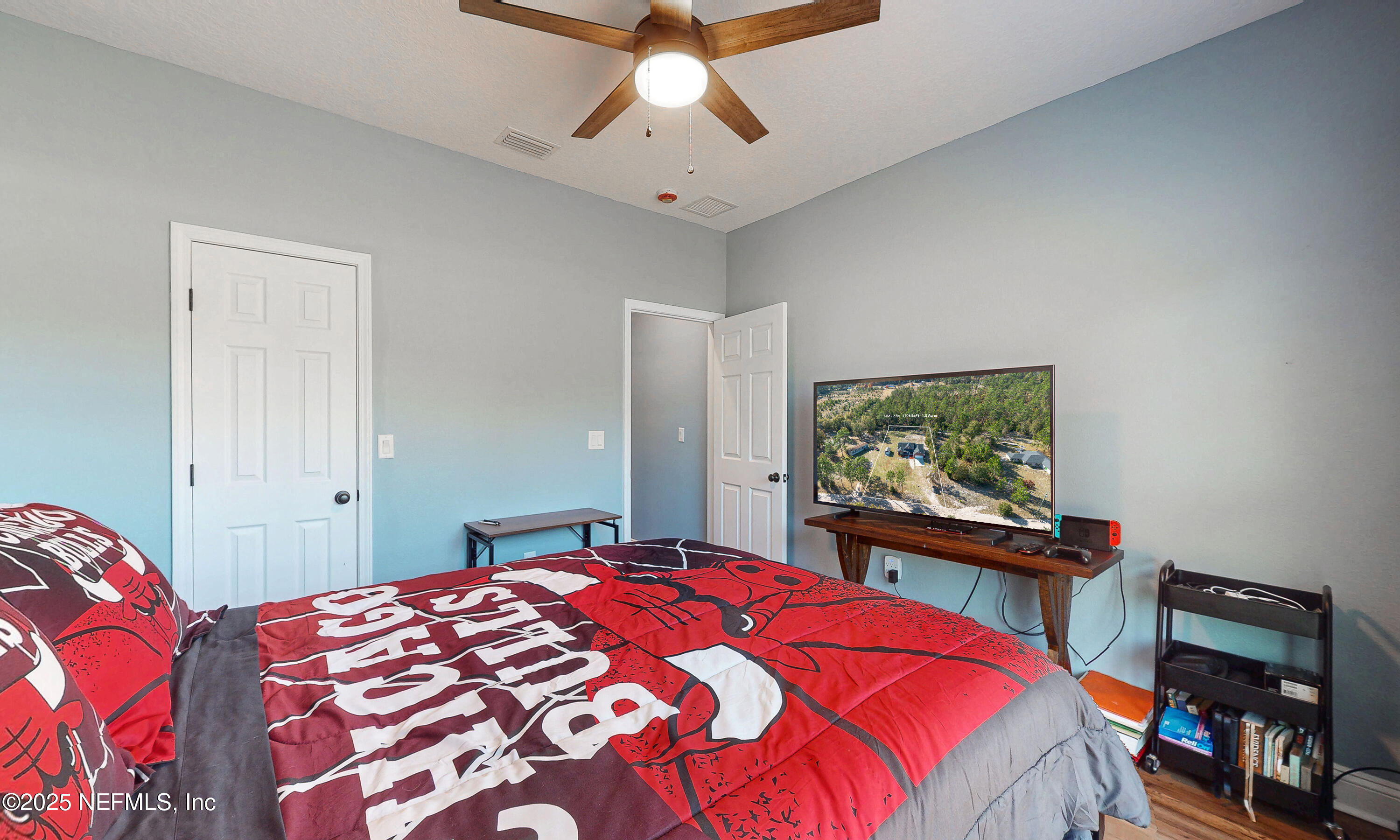 2414 Range Line Road Middleburg, FL 32068 - Photo 26 of 39 a bedroom with a bed and a flat screen tv