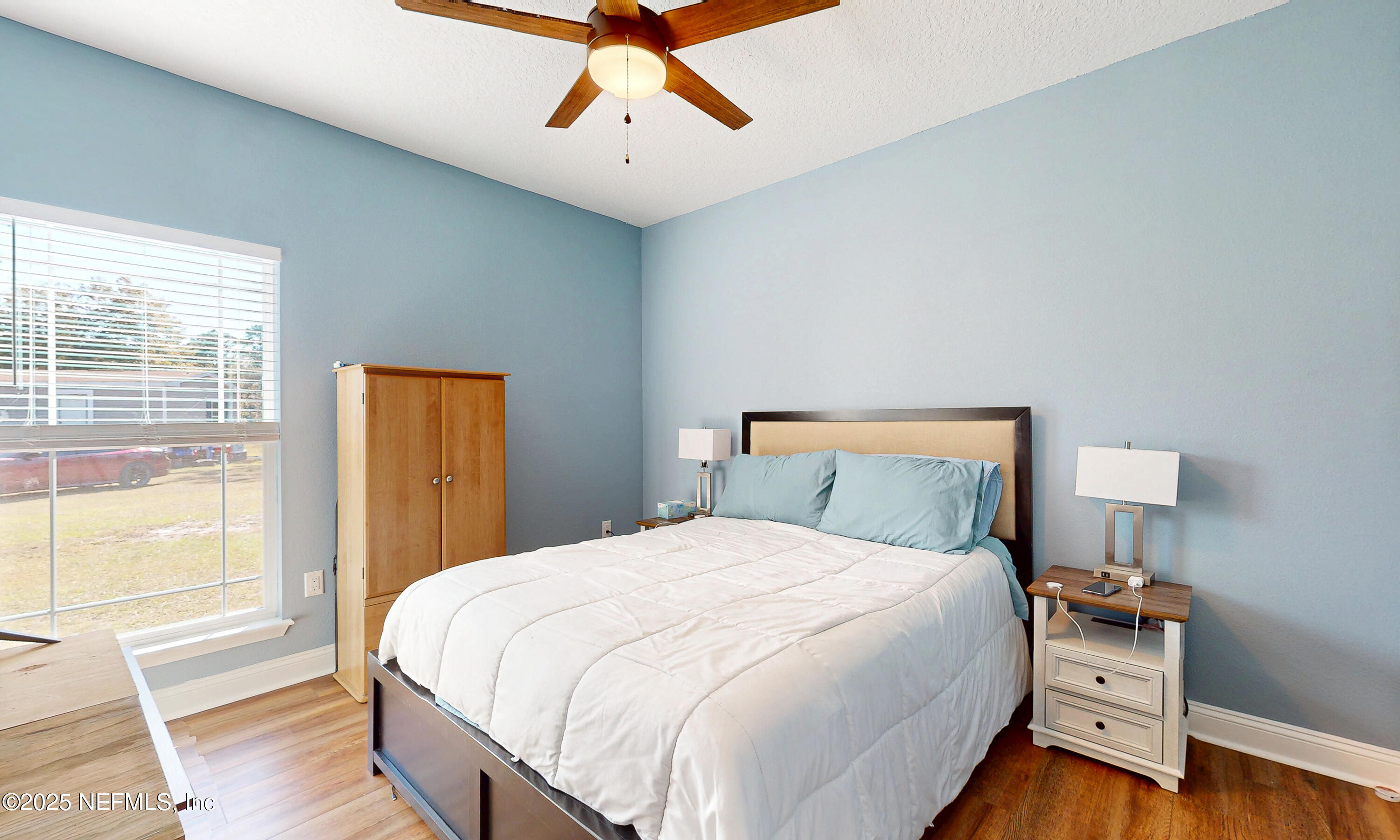 2414 Range Line Road Middleburg, FL 32068 - Photo 27 of 39 a bedroom with a bed and wooden floor