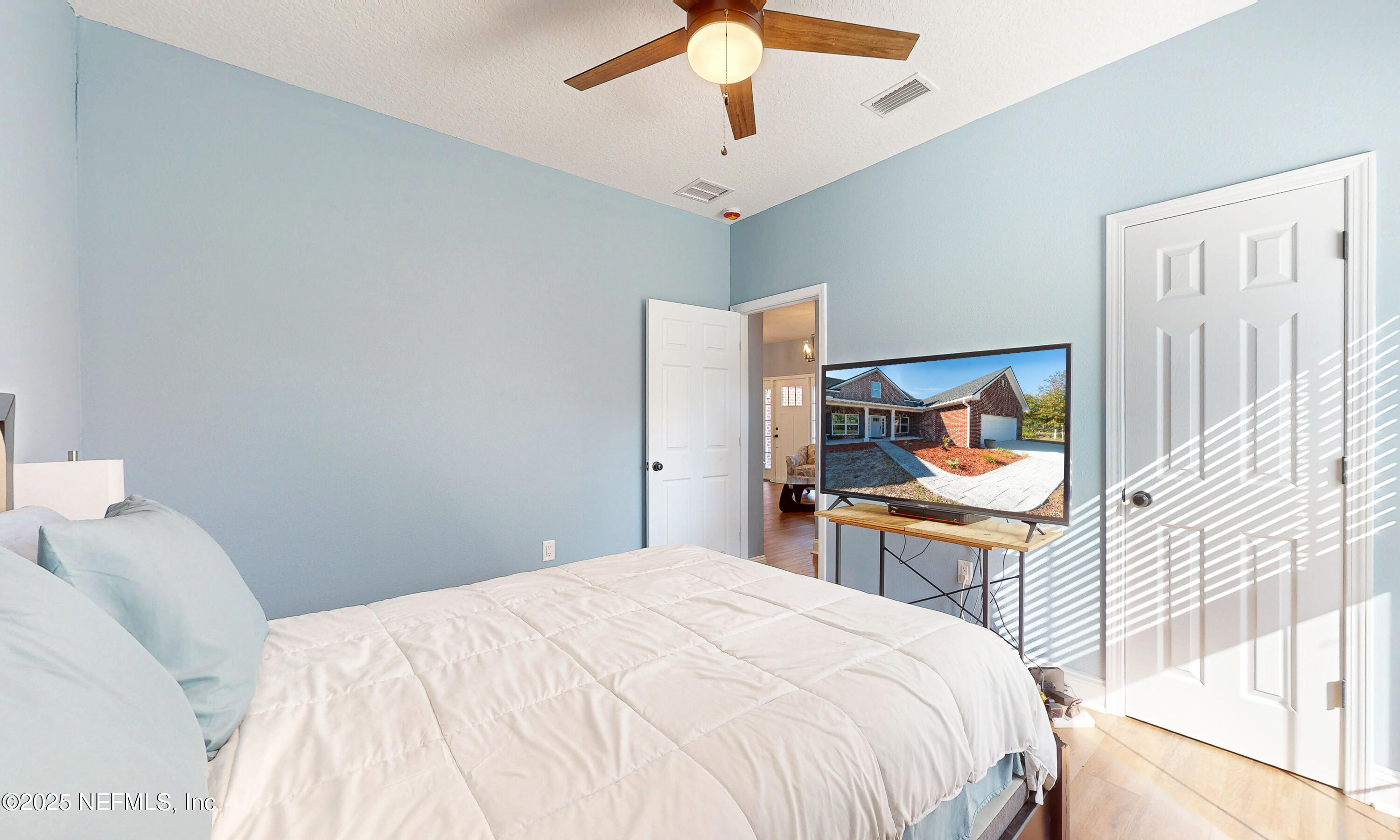 2414 Range Line Road Middleburg, FL 32068 - Photo 28 of 39 a bedroom with a bed and a chandelier