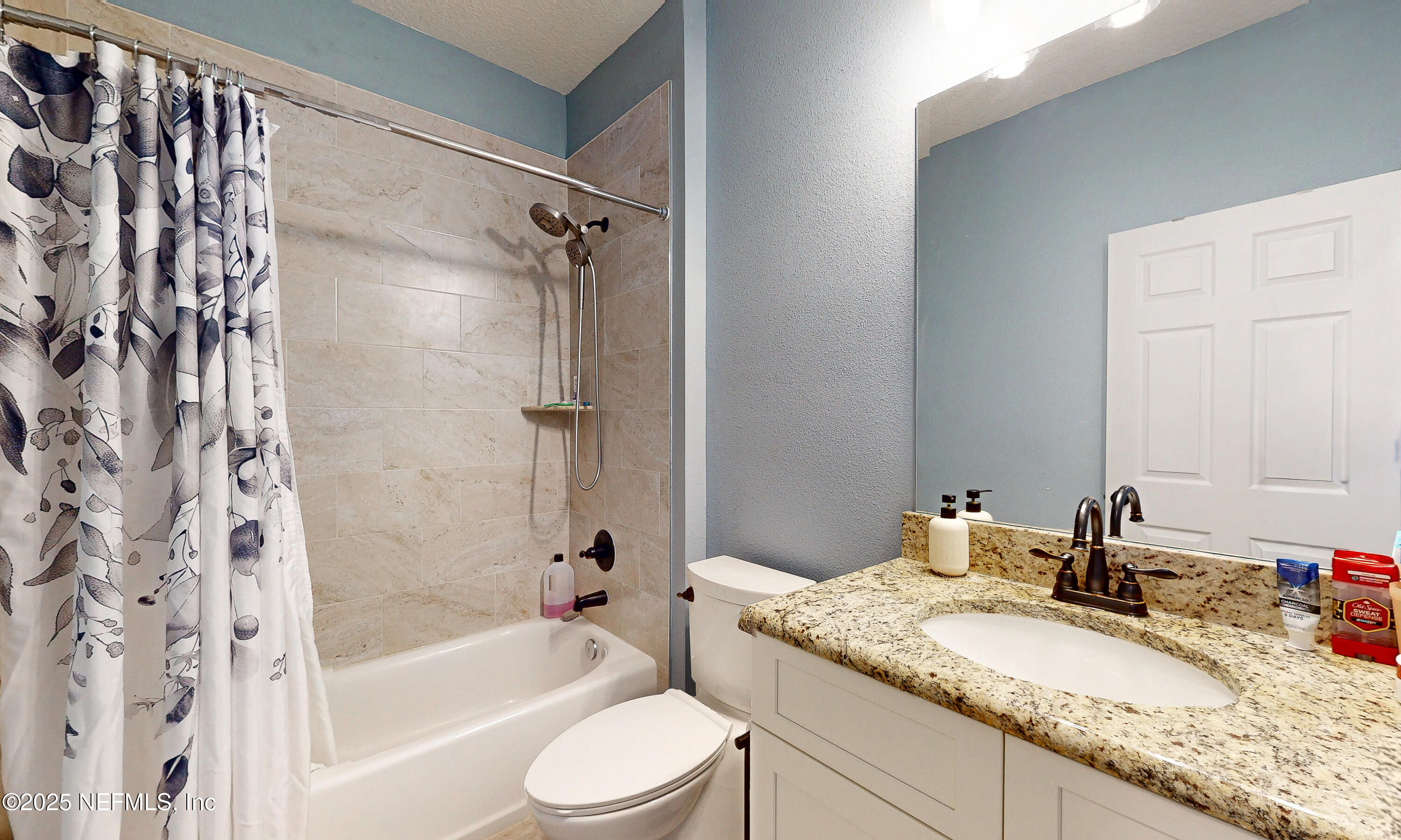 2414 Range Line Road Middleburg, FL 32068 - Photo 29 of 39 a bathroom with a granite countertop sink toilet and shower