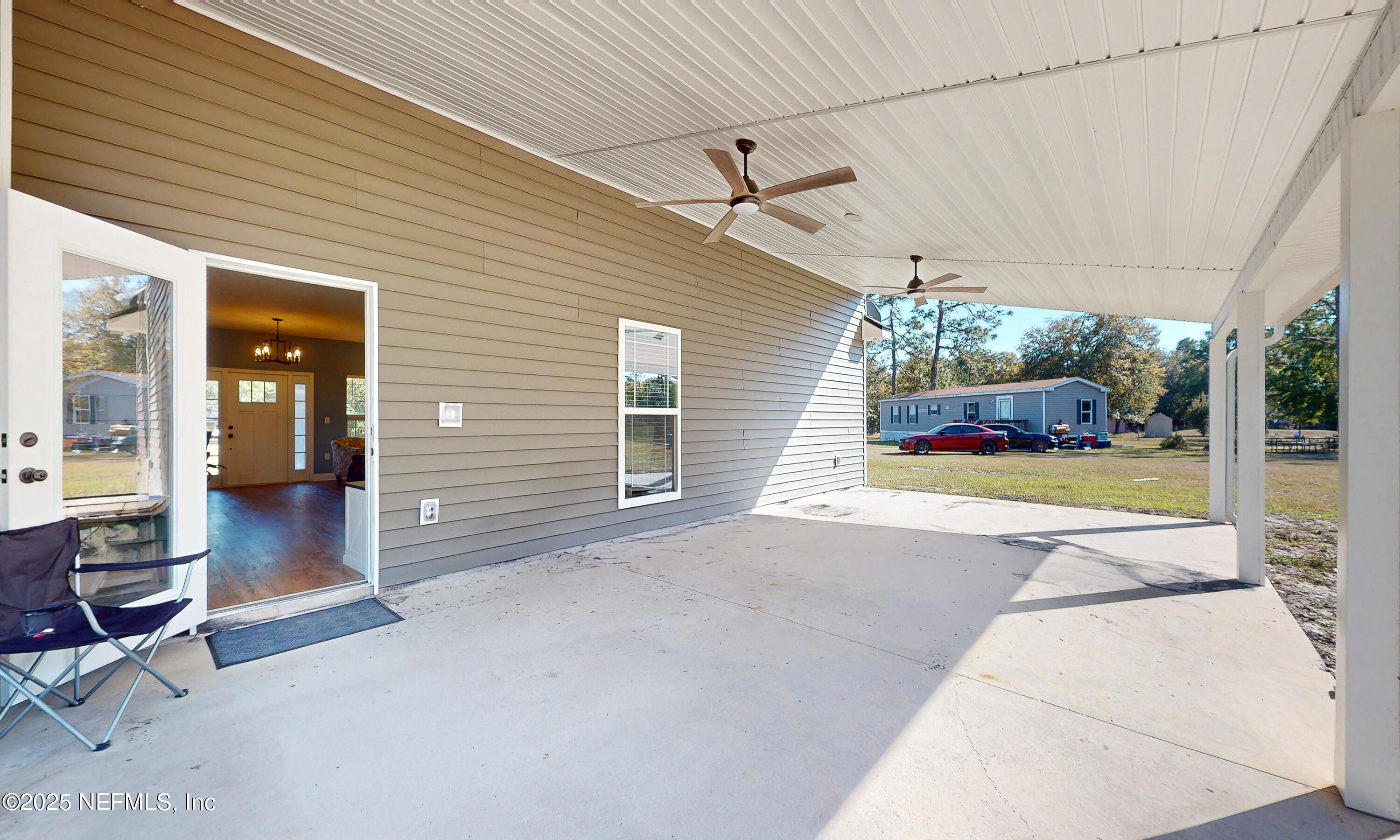 2414 Range Line Road Middleburg, FL 32068 - Photo 32 of 39 a view of a porch with chairs and backyard
