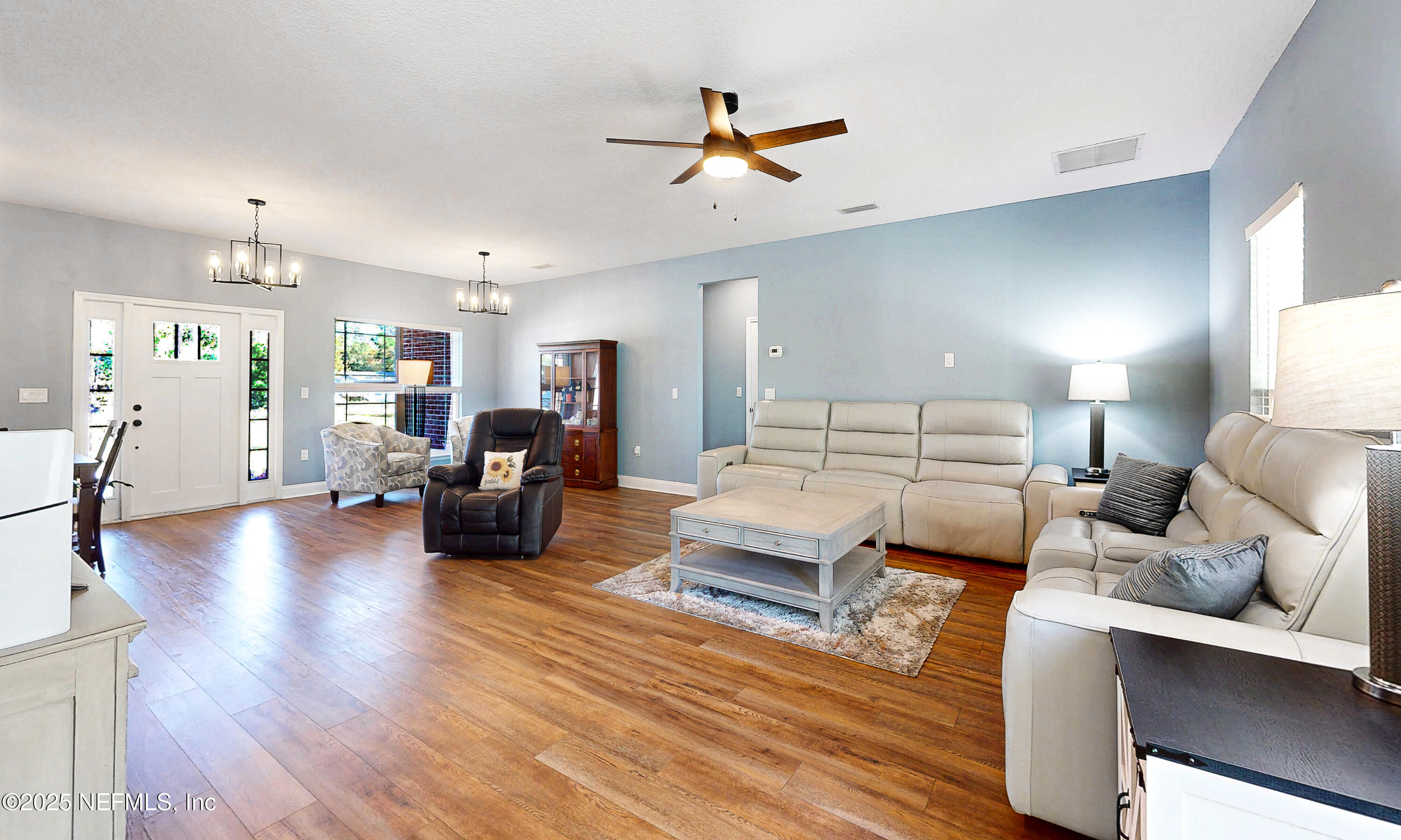 2414 Range Line Road Middleburg, FL 32068 - Photo 9 of 39 a bed room with furniture and a wooden floor