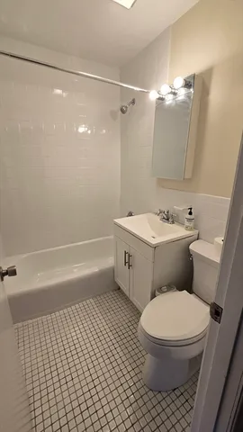 a bathroom with a toilet a sink and shower