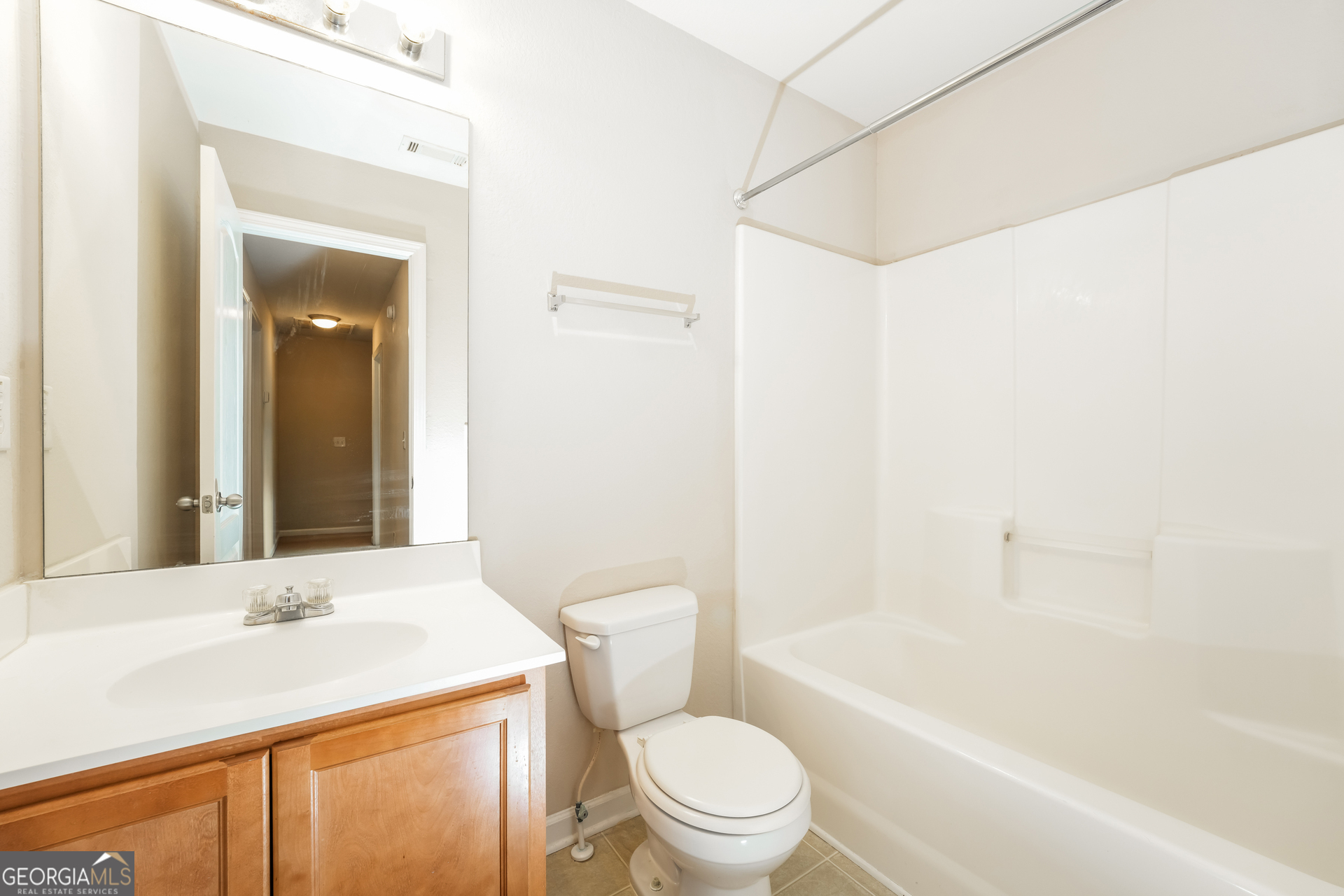 1259 Chinon Point Lithonia, GA 30058 - Photo 13 of 15 a bathroom with a sink a toilet and shower