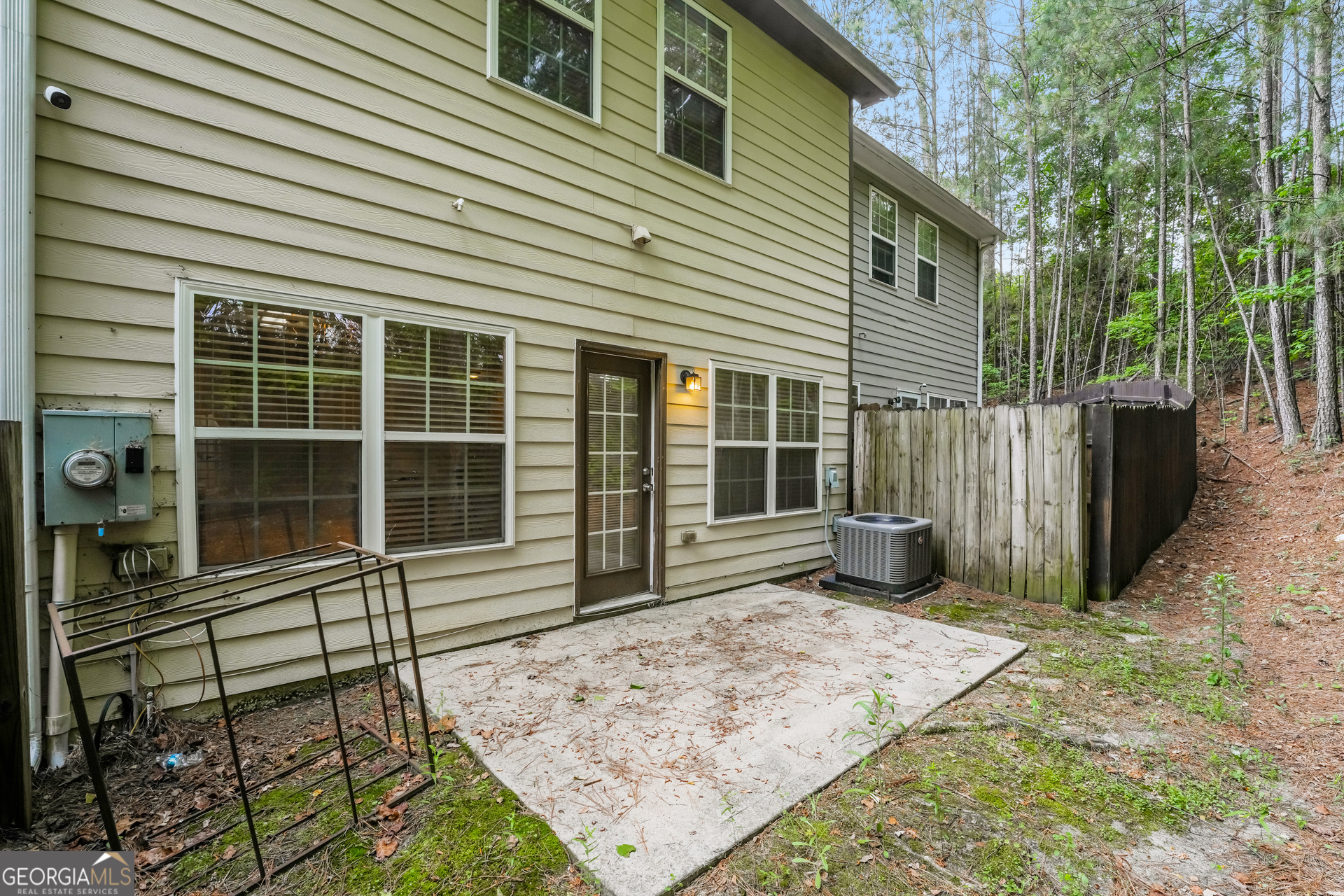 1259 Chinon Point Lithonia, GA 30058 - Photo 14 of 15 a view of a house with a large window and wooden fence