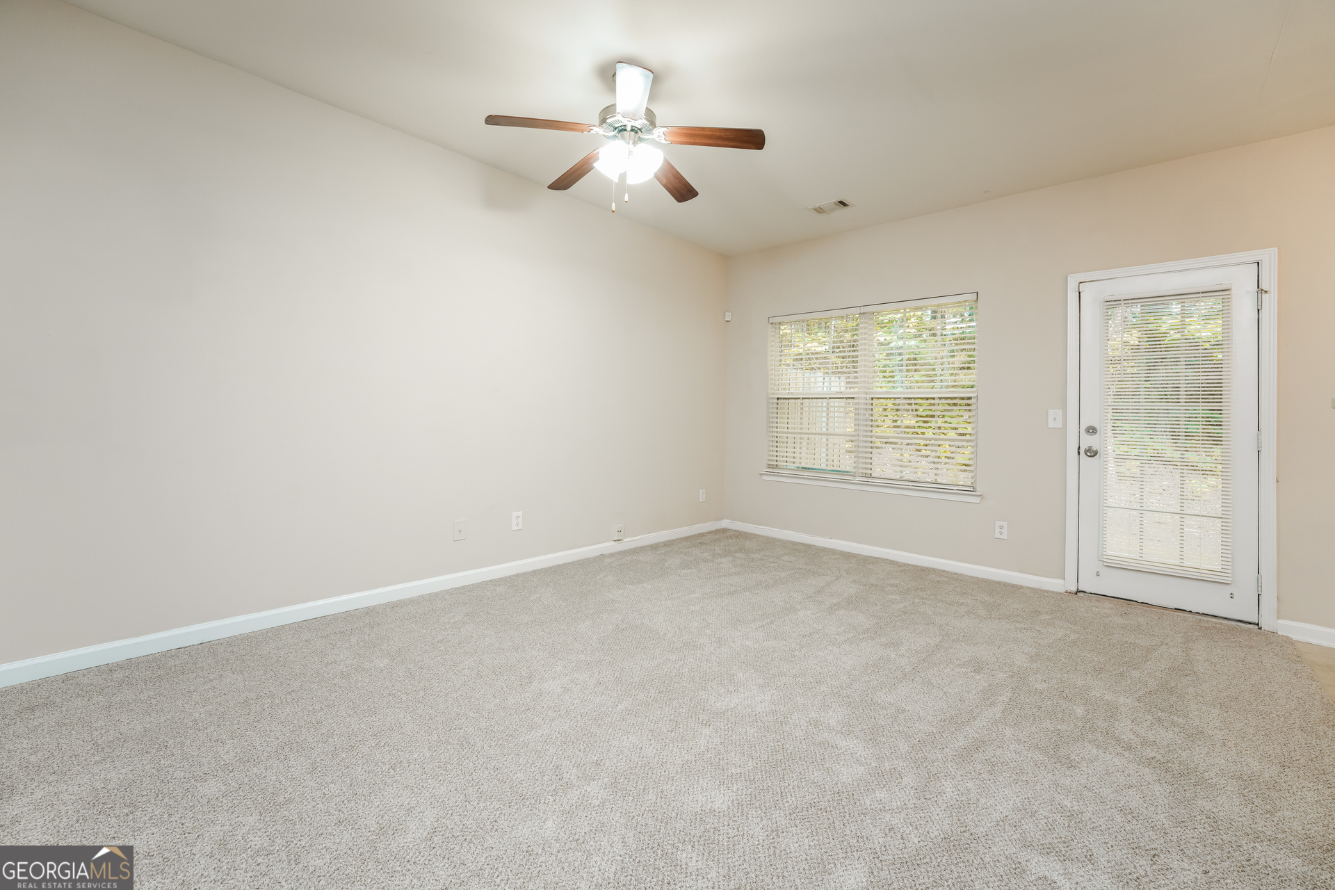 1259 Chinon Point Lithonia, GA 30058 - Photo 2 of 15 an empty room with a empty space and a ceiling fan