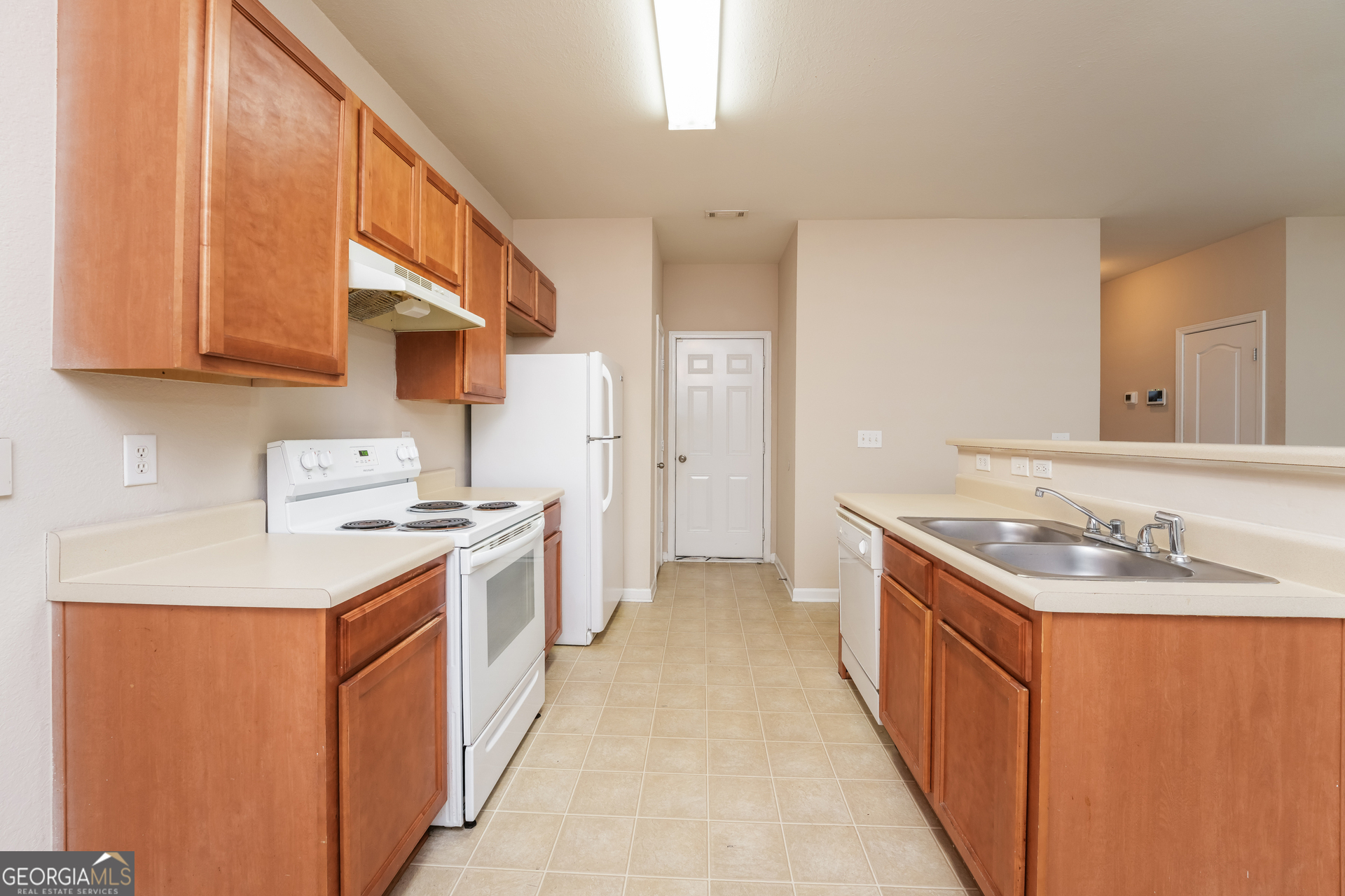 1259 Chinon Point Lithonia, GA 30058 - Photo 5 of 15 a kitchen with stainless steel appliances granite countertop a sink stove and refrigerator