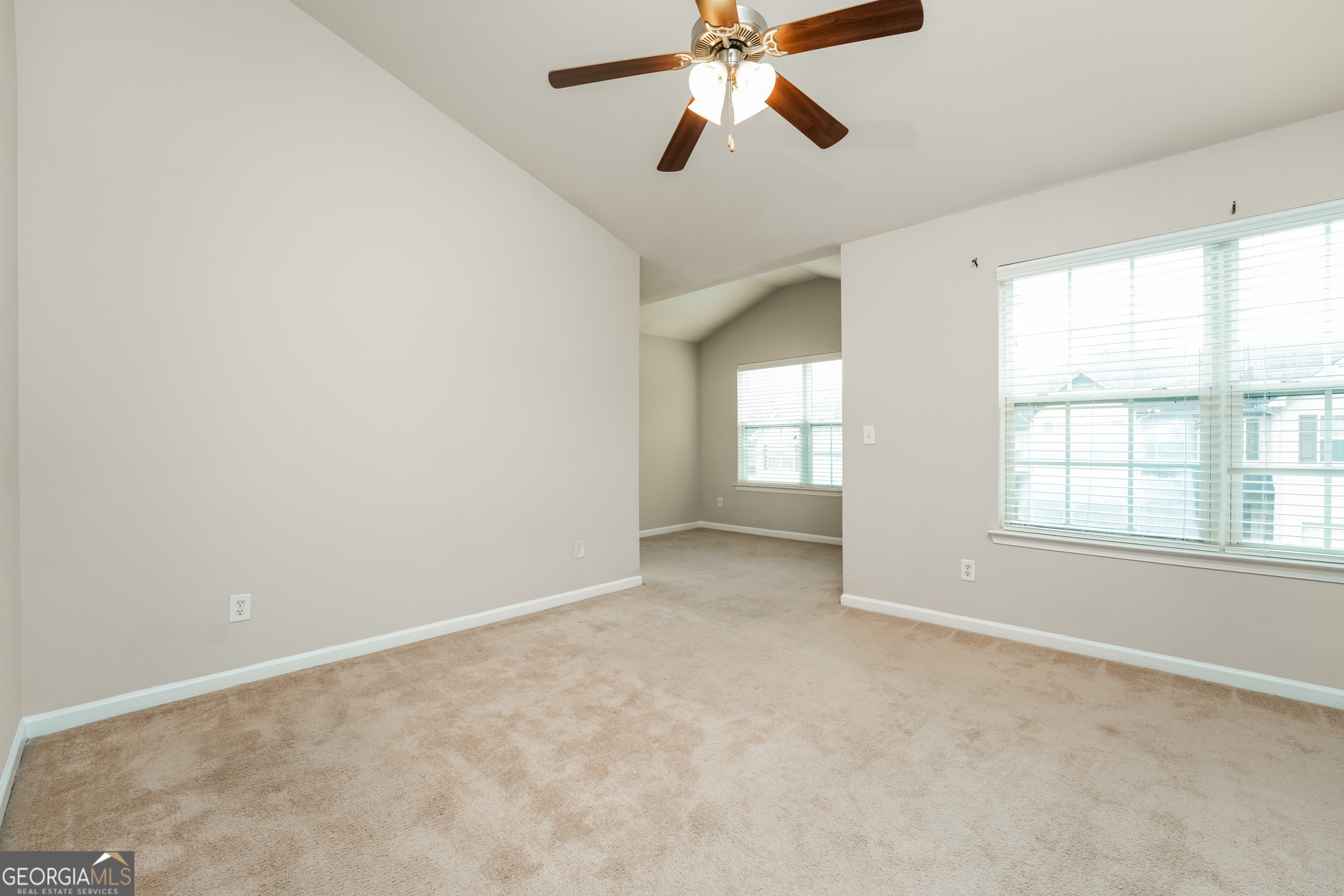 1259 Chinon Point Lithonia, GA 30058 - Photo 8 of 15 an empty room with windows and fan