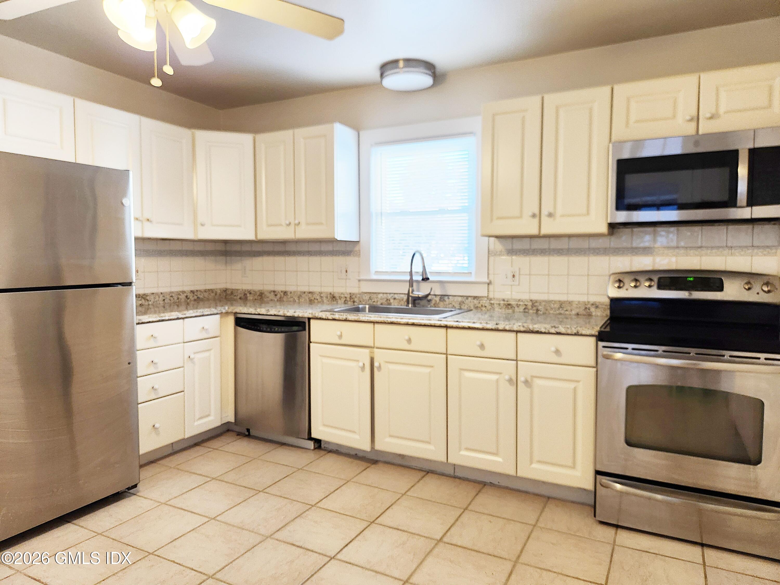 79 Valley Road Cos Cob, CT 06807 - Photo 4 of 20 a kitchen with cabinets stainless steel appliances and a sink