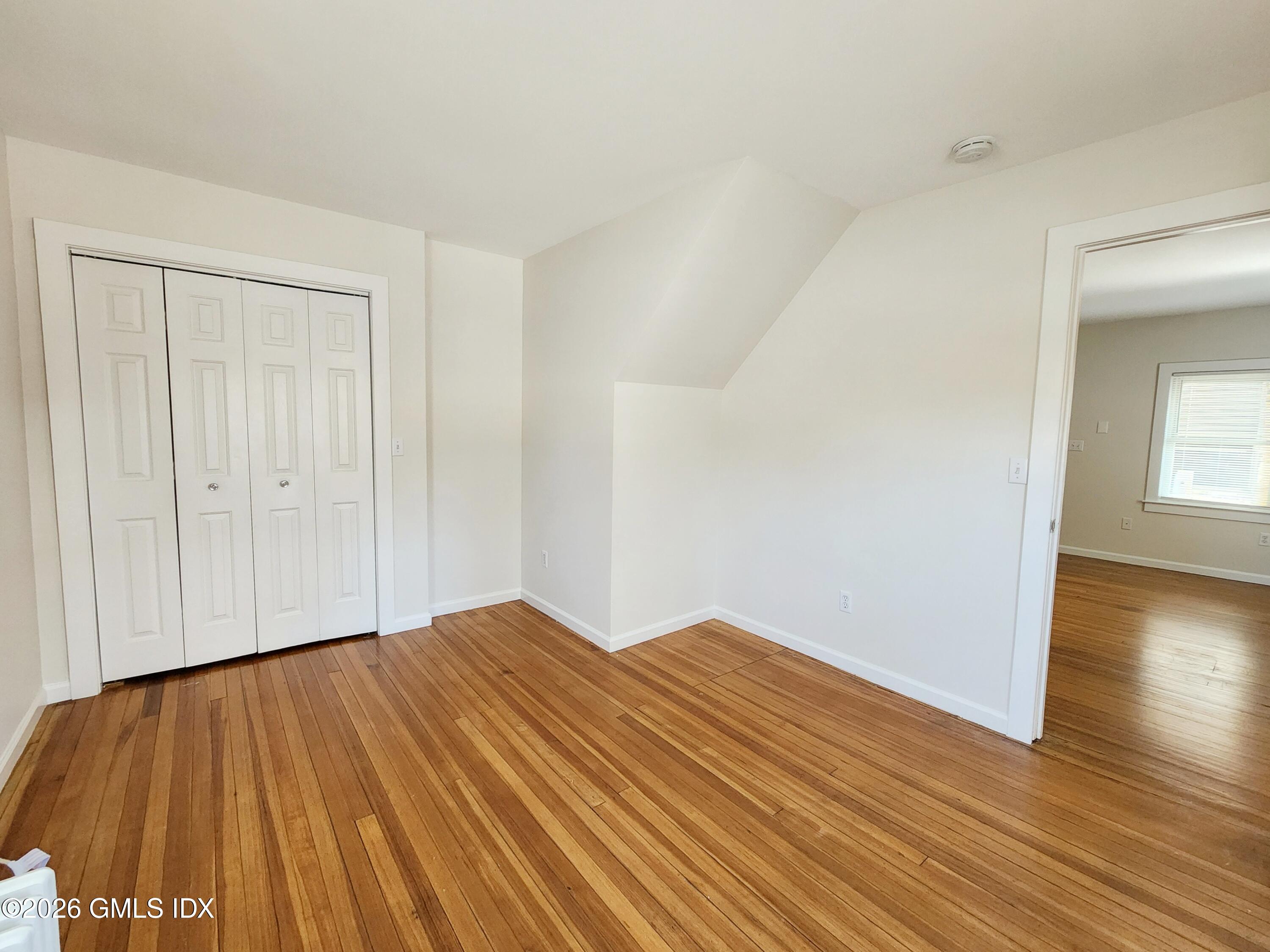 79 Valley Road Cos Cob, CT 06807 - Photo 6 of 20 a view of an empty room with wooden floor