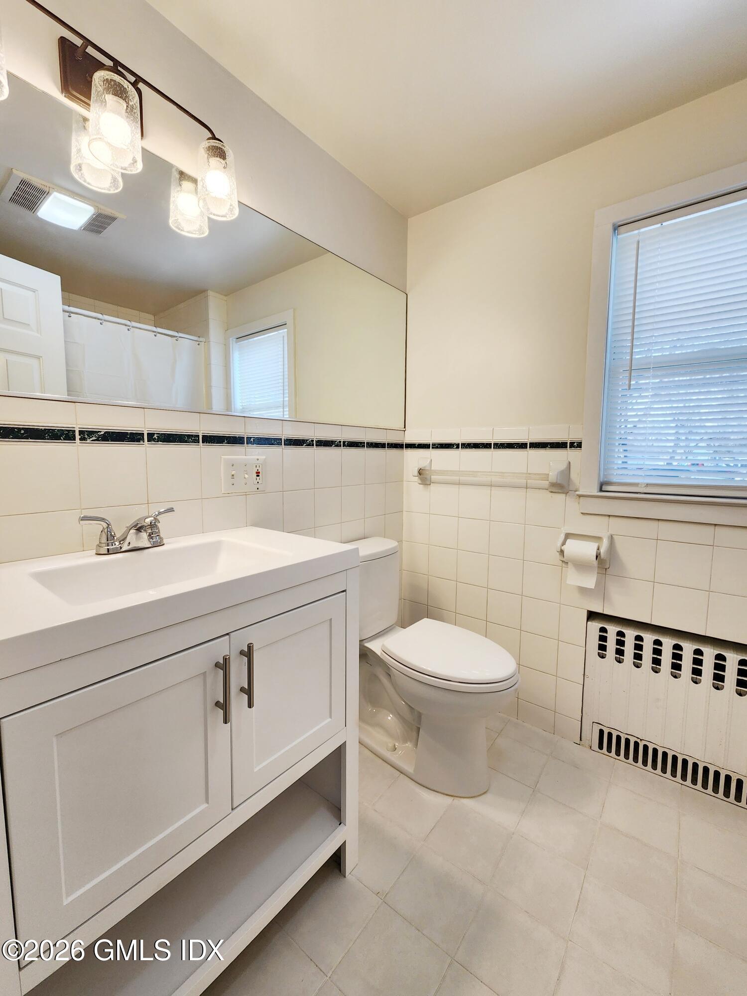 79 Valley Road Cos Cob, CT 06807 - Photo 8 of 20 a bathroom with a sink a toilet and a mirror
