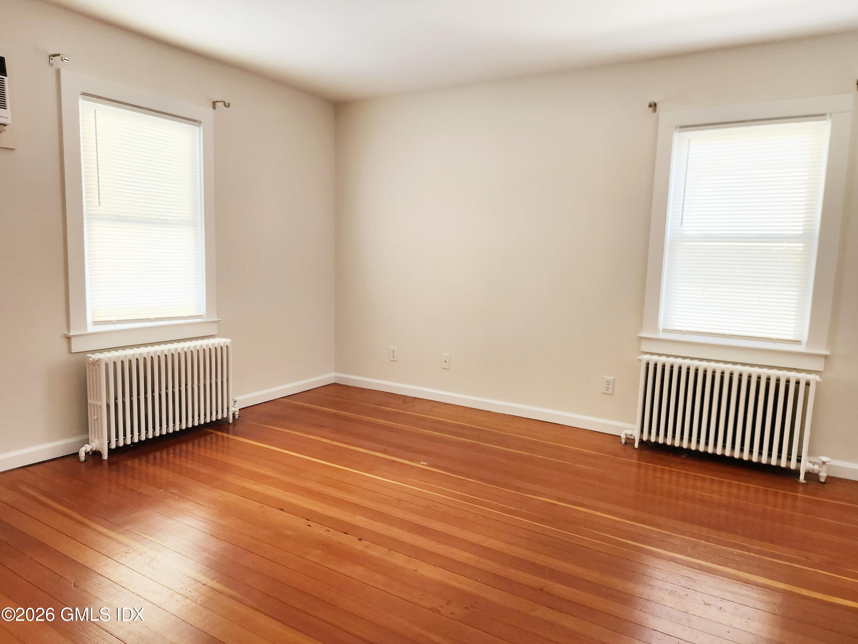 79 Valley Road Cos Cob, CT 06807 - Photo 9 of 20 an empty room with wooden floor and a window