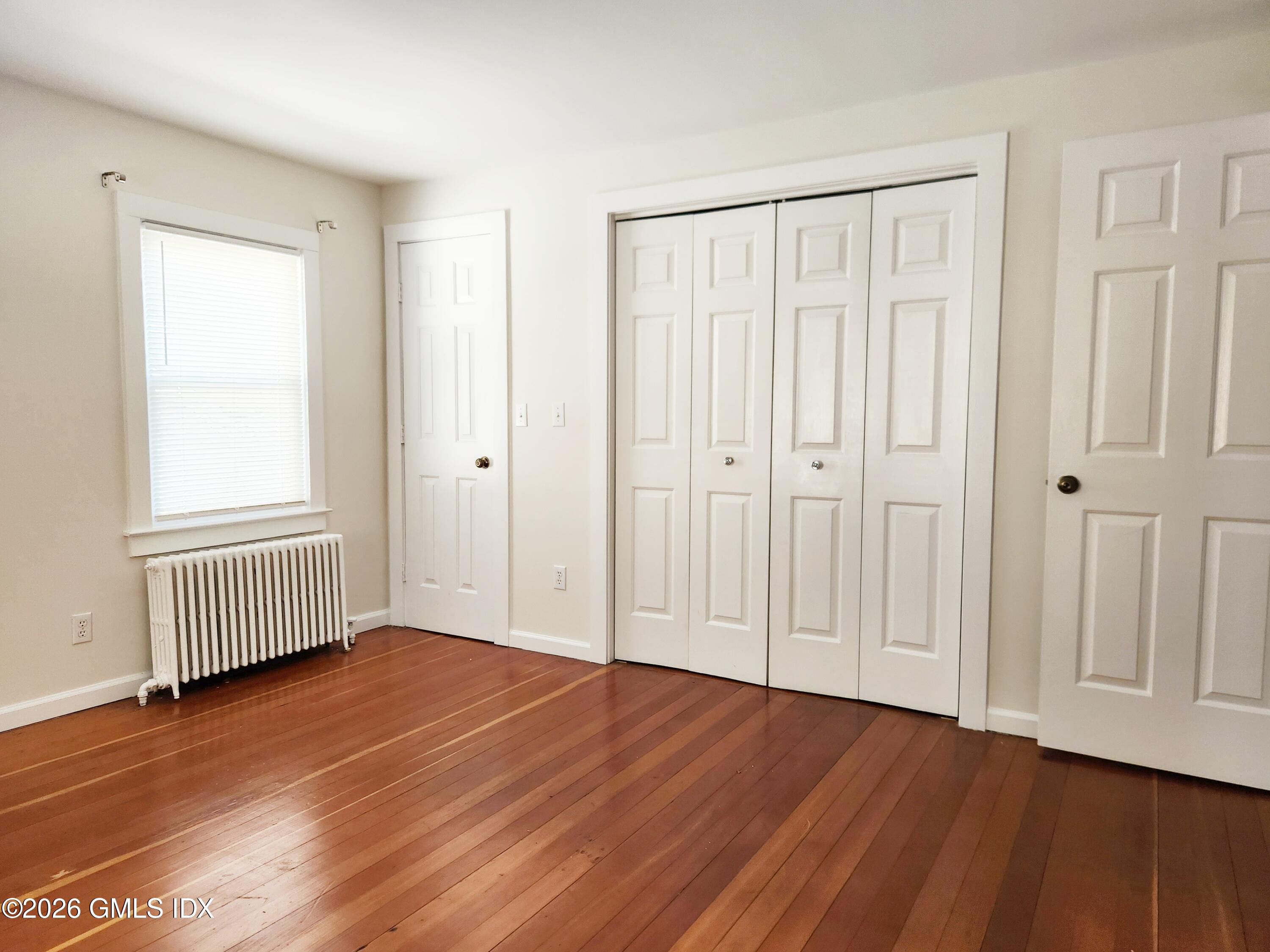 79 Valley Road Cos Cob, CT 06807 - Photo 10 of 20 an empty room with wooden floor and windows