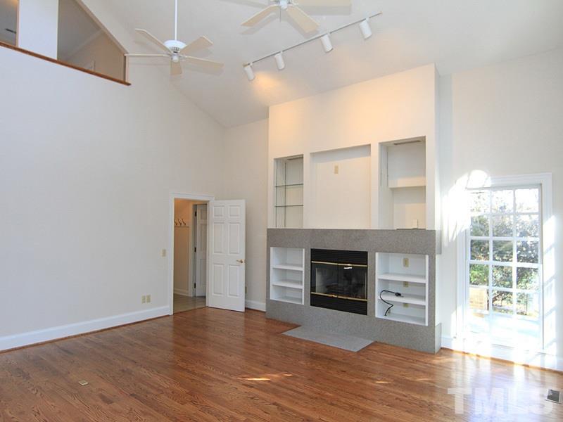 268 Log Barn Road Pittsboro, NC 27312 - Photo 9 of 25 Family Room has Vaulted Ceilings, Gas Log Fireplace & Built-In Bookcase surround