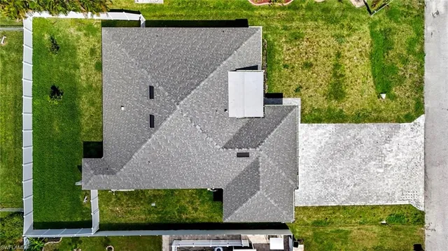 an aerial view of multiple houses with a yard