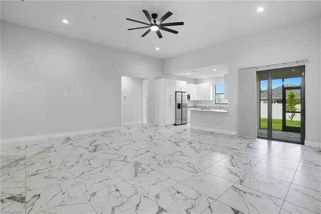 a view of a kitchen with a sink and a refrigerator