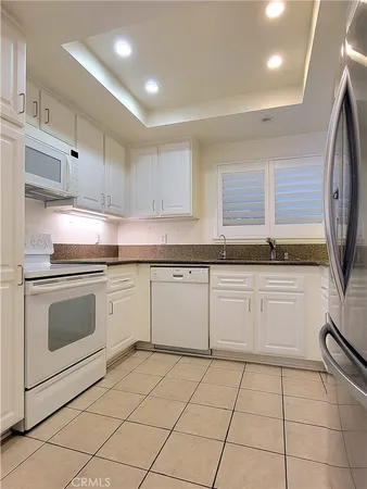 a kitchen with a stove sink and cabinets