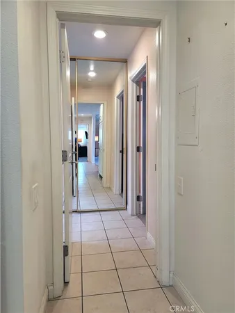 a view of a hallway with a furniture and a mirror