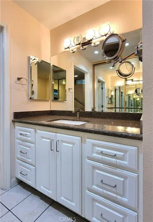 a bathroom with a sink and a large mirror