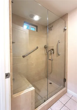 a bathroom with a shower and a bath tub