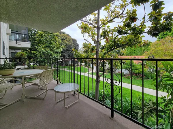 a view of a chair and tables in the balcony