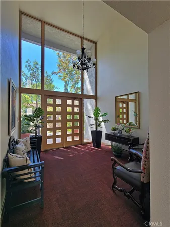 a living room with furniture and a floor to ceiling window