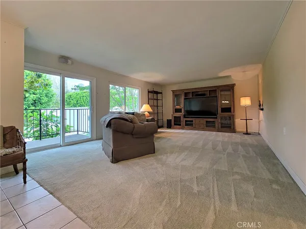 a living room with furniture and large windows
