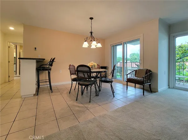 a view of a dining room with furniture and chandelier