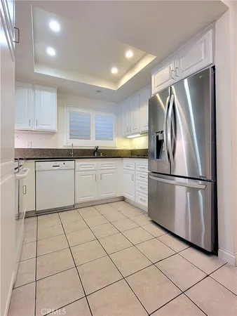 a kitchen with stainless steel appliances granite countertop a refrigerator sink and microwave