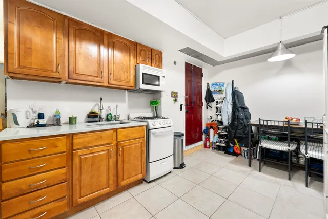 a kitchen with stainless steel appliances granite countertop a refrigerator and wooden cabinets