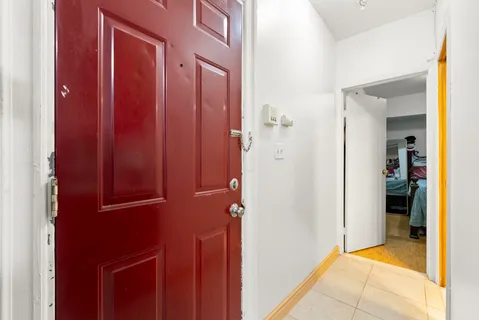 a view of a hallway with closet and a bathroom