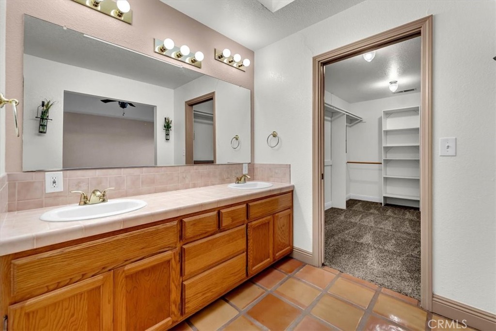 4730 Hall Corning, CA 96021 - Photo 26 of 70 a spacious bathroom with a double vanity sink and a mirror
